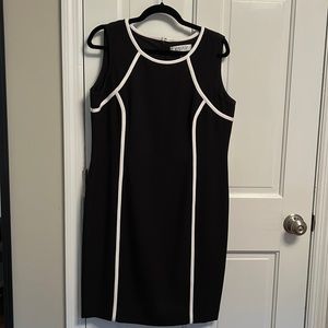 Adorable shift dress with slimming piping.